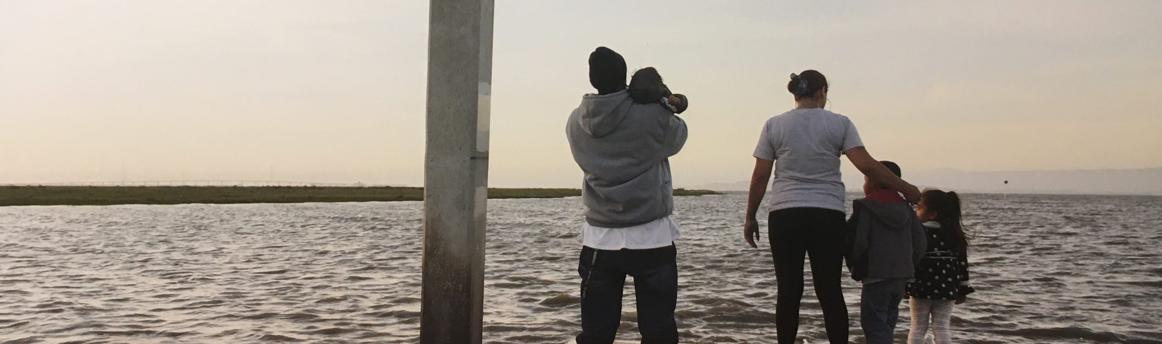 Family looking out from the pier at the San Francisco Bay